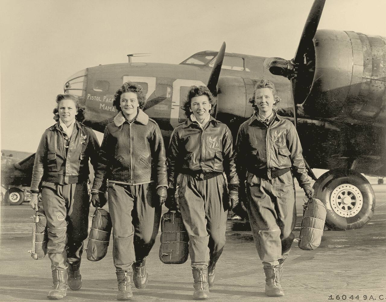 Four Women Airforce Service Pilots walk away from their B-17 Flying Fortress, Pistol Packin' Mama, at Lockbourne Army Air Field, Ohio